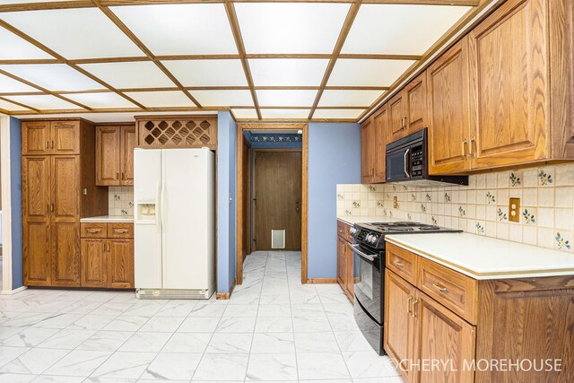 6555 Waybridge Dr SE, Grand Rapids, MI 49546 - kitchen featuring black appliances, light marble finish floors, and brown cabinets