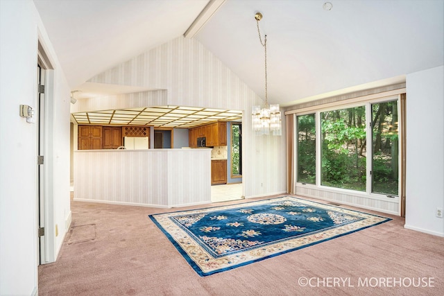 6555 Waybridge Dr SE, Grand Rapids, MI 49546 - unfurnished dining area featuring lofted ceiling, carpet flooring, a chandelier, and wallpapered walls
