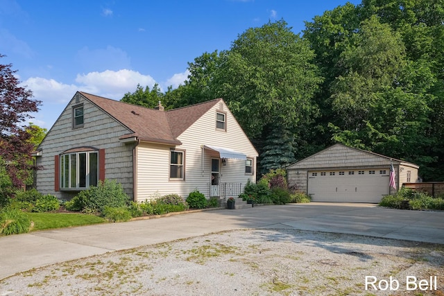 3897 Obrien St SW, Grand Rapids, MI 49534 - view of front of house featuring an outdoor structure, a garage, and a shingled roof