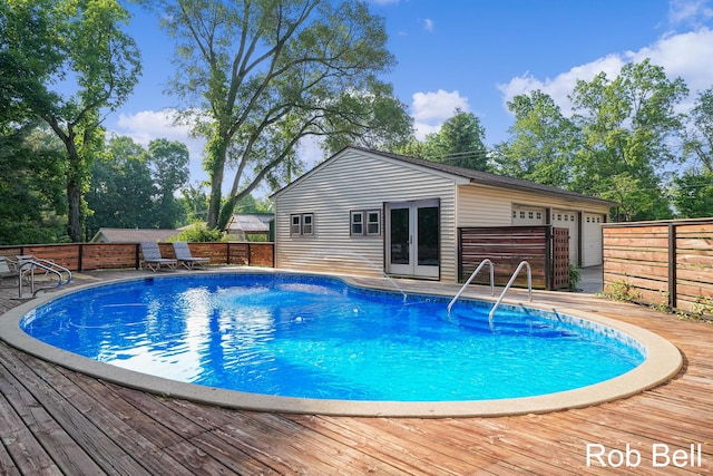 3897 Obrien St SW, Grand Rapids, MI 49534 - view of swimming pool featuring a wooden deck, a fenced backyard, french doors, and an outdoor structure