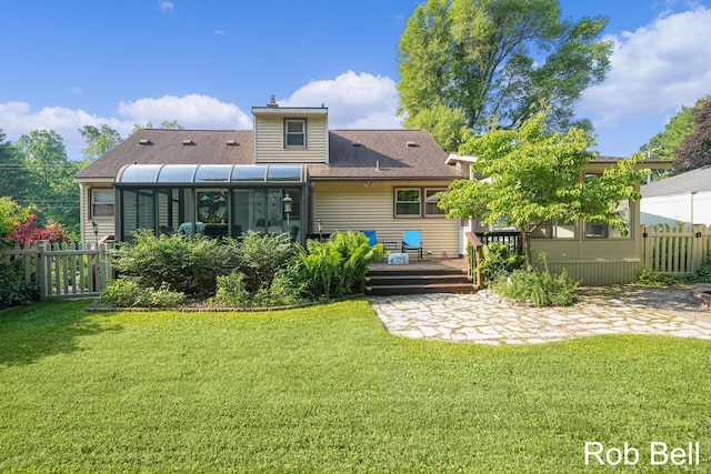 3897 Obrien St SW, Grand Rapids, MI 49534 - rear view of house featuring a wooden deck, a sunroom, and a chimney