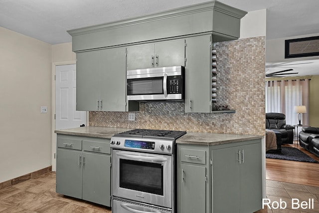 3897 Obrien St SW, Grand Rapids, MI 49534 - kitchen with appliances with stainless steel finishes, backsplash, gray cabinets, and light countertops