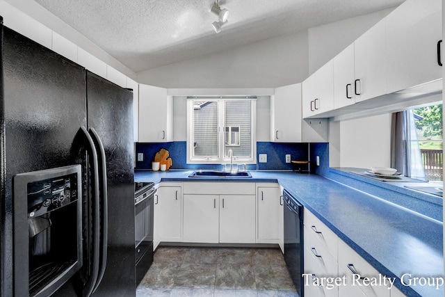 271 Rolling Greene Dr NW, Grand Rapids, MI 49534 - kitchen featuring black appliances, vaulted ceiling, decorative backsplash, white cabinetry, and a textured ceiling
