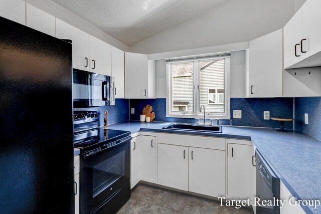271 Rolling Greene Dr NW, Grand Rapids, MI 49534 - kitchen featuring black appliances, vaulted ceiling, decorative backsplash, white cabinets, and a textured ceiling