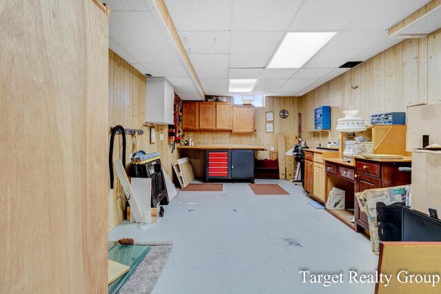 271 Rolling Greene Dr NW, Grand Rapids, MI 49534 - basement featuring a workshop area, wooden walls, and a paneled ceiling
