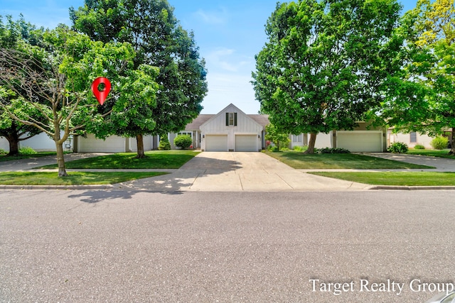 271 Rolling Greene Dr NW, Grand Rapids, MI 49534 - view of front of property with a front lawn, concrete driveway, and an attached garage