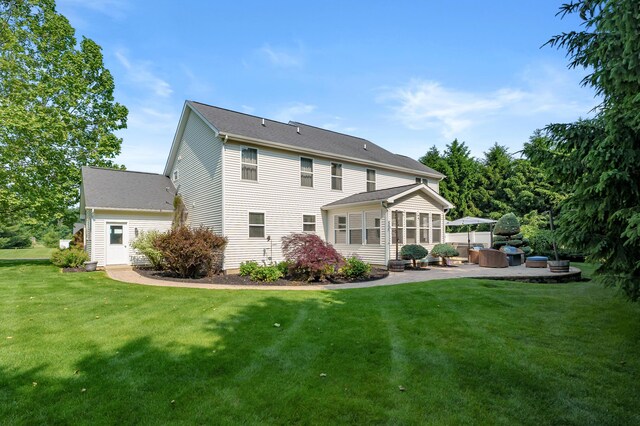 16069 Grazenview St, Schoolcraft, MI 49087 - rear view of house featuring a patio, a yard, and a sunroom