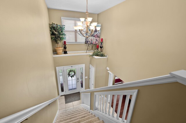 16069 Grazenview St, Schoolcraft, MI 49087 - staircase featuring a chandelier, healthy amount of natural light, and tile patterned flooring