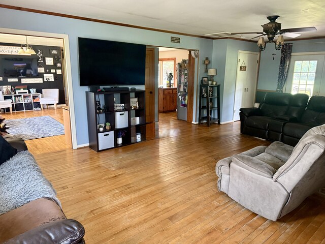 15030 N A Dr N, Marshall, MI 49068 - living area with ceiling fan, light wood-style floors, and crown molding