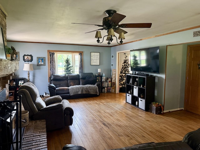 15030 N A Dr N, Marshall, MI 49068 - living area featuring ceiling fan, wood-type flooring, ornamental molding, and a fireplace