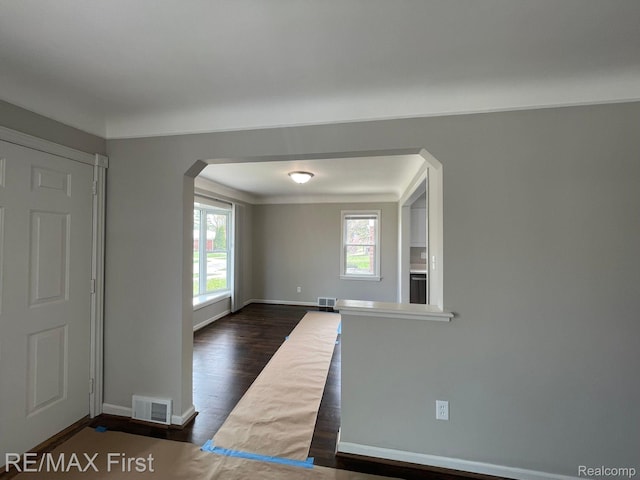 21128 Kenmore Ave, Harper Woods, MI 48225 - spare room featuring arched walkways and dark wood finished floors