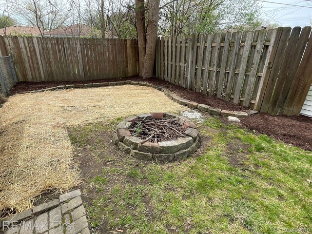 21128 Kenmore Ave, Harper Woods, MI 48225 - fenced backyard with a fire pit