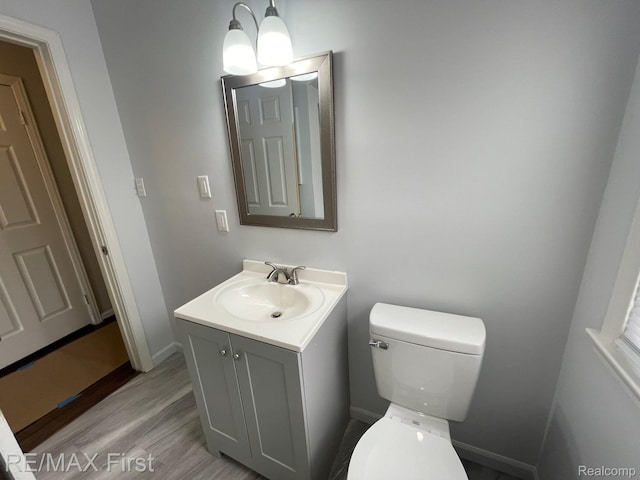 21128 Kenmore Ave, Harper Woods, MI 48225 - half bath featuring vanity and wood finished floors