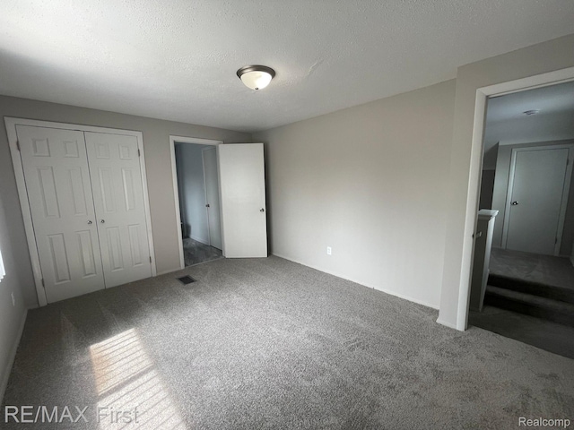 21128 Kenmore Ave, Harper Woods, MI 48225 - unfurnished bedroom with carpet, a closet, and a textured ceiling
