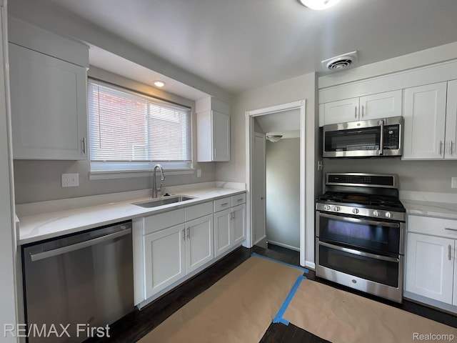 21128 Kenmore Ave, Harper Woods, MI 48225 - kitchen featuring appliances with stainless steel finishes, light countertops, and white cabinetry