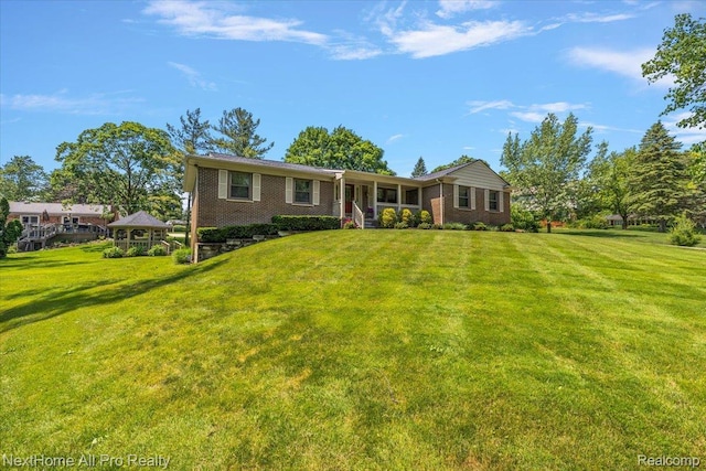 22219 Connemara Dr, Northville, MI 48167 - single story home featuring a front lawn, brick siding, and a gazebo