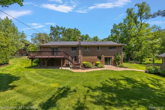 22219 Connemara Dr, Northville, MI 48167 - rear view of property featuring a wooden deck, stairway, a yard, and a chimney
