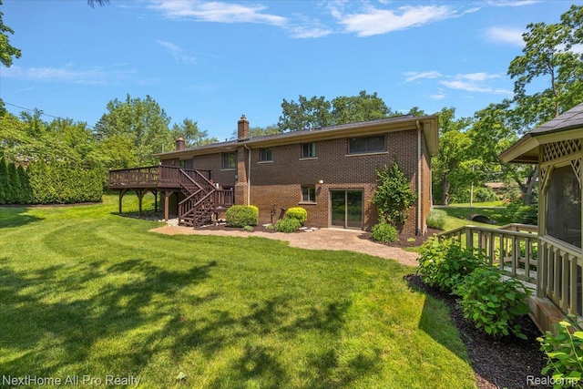 22219 Connemara Dr, Northville, MI 48167 - back of property with stairway, a wooden deck, a chimney, brick siding, and a yard