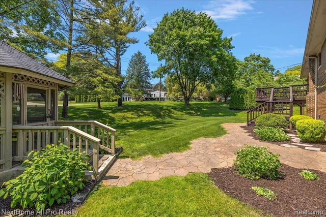 22219 Connemara Dr, Northville, MI 48167 - view of green lawn with stairway and a wooden deck
