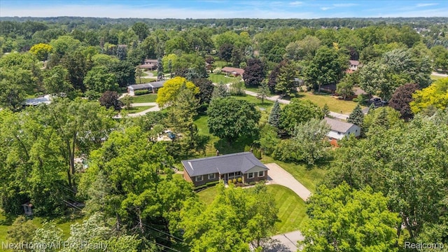 22219 Connemara Dr, Northville, MI 48167 - aerial view of property and surrounding area featuring a heavily wooded area