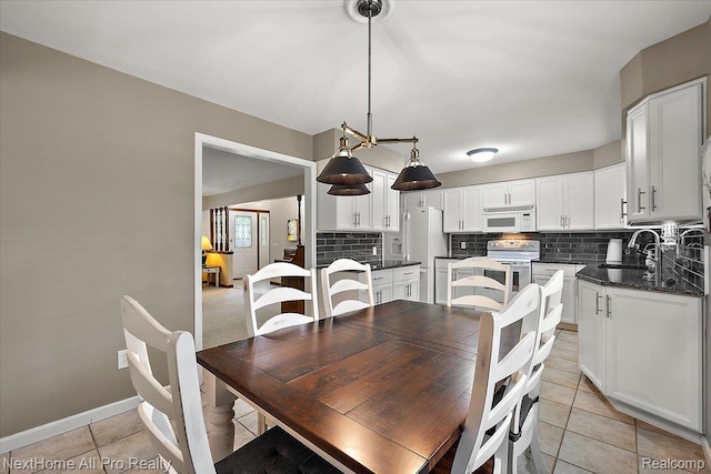 22219 Connemara Dr, Northville, MI 48167 - dining room featuring light tile patterned flooring and baseboards