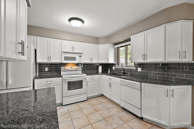 22219 Connemara Dr, Northville, MI 48167 - kitchen featuring white appliances, white cabinets, dark stone counters, backsplash, and light tile patterned floors