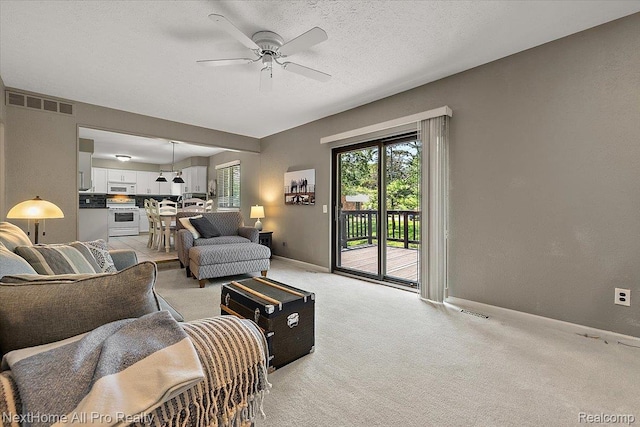 22219 Connemara Dr, Northville, MI 48167 - living area with ceiling fan and light colored carpet