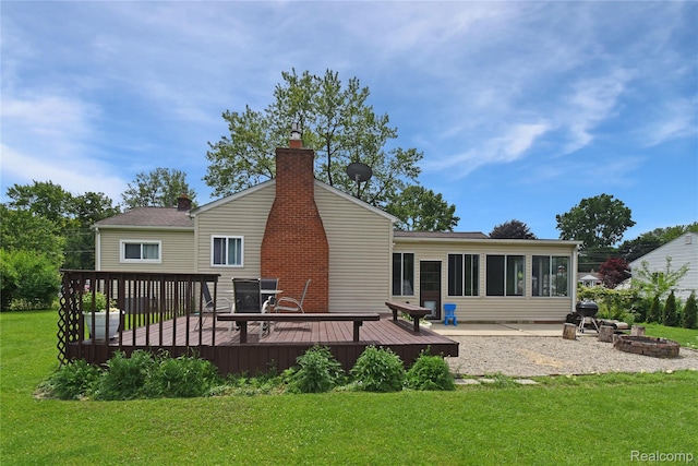 4466 Eastwood Dr, Swartz Creek, MI 48473 - rear view of house with a wooden deck, a yard, a chimney, and an outdoor fire pit