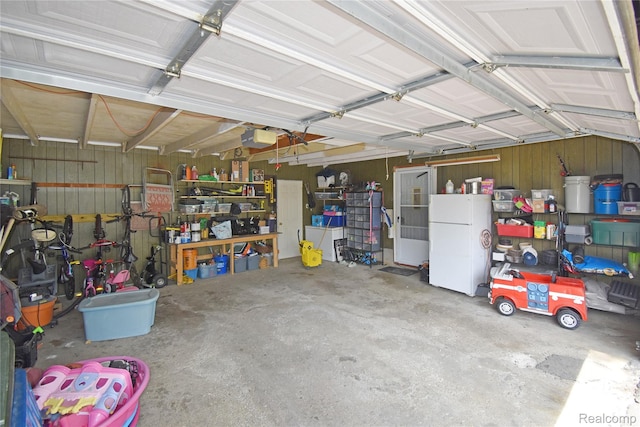4466 Eastwood Dr, Swartz Creek, MI 48473 - garage with freestanding refrigerator and a garage door opener