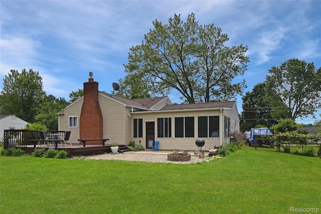 4466 Eastwood Dr, Swartz Creek, MI 48473 - rear view of property featuring a wooden deck, a fire pit, a yard, and a chimney