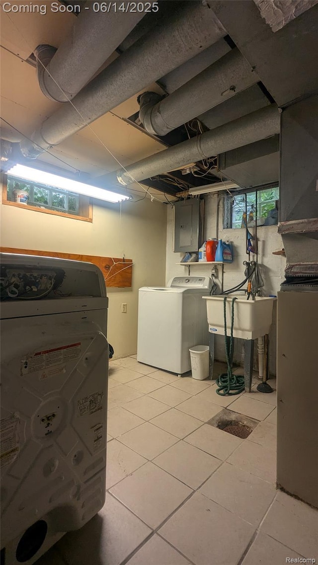 100 Oliver St, Pontiac, MI 48342 - basement with electric panel, washing machine and dryer, and light tile patterned floors