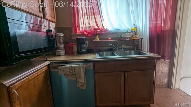 100 Oliver St, Pontiac, MI 48342 - kitchen featuring dishwasher, black microwave, light tile patterned floors, brown cabinets, and backsplash