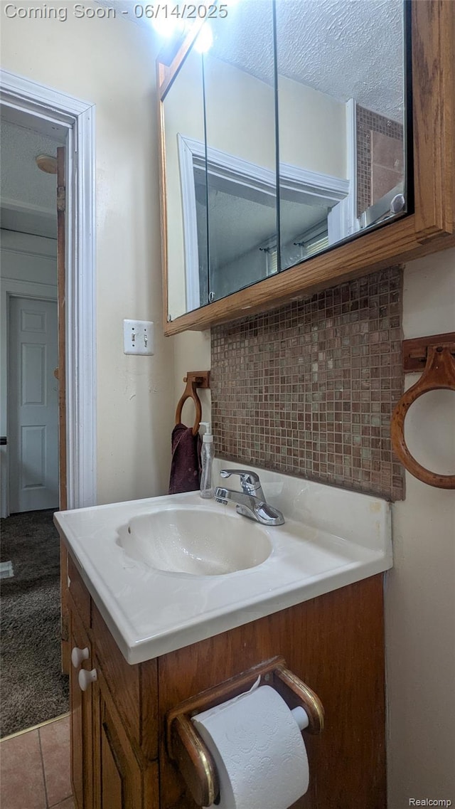 100 Oliver St, Pontiac, MI 48342 - bathroom with vanity, tasteful backsplash, and tile patterned floors