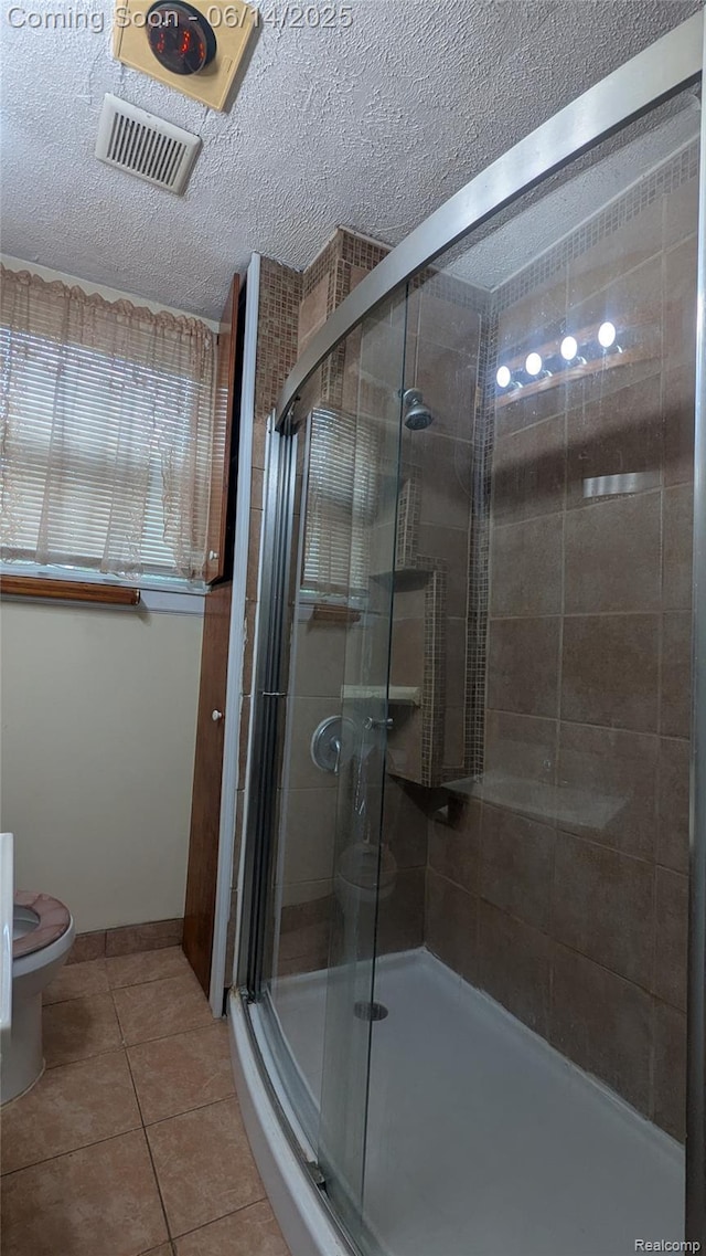 100 Oliver St, Pontiac, MI 48342 - bathroom with tile patterned floors, a shower stall, and a textured ceiling