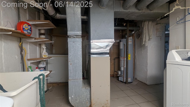 100 Oliver St, Pontiac, MI 48342 - unfinished basement with gas water heater, washer / dryer, and tile patterned floors