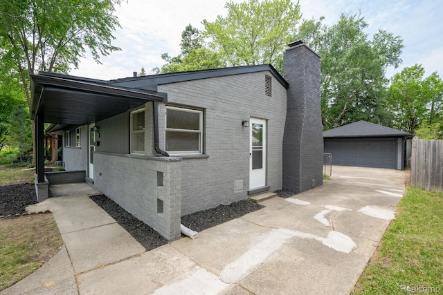 32431 Halmich Dr, Warren, MI 48092 - view of front of property featuring entry steps, a chimney, an outdoor structure, a detached garage, and brick siding