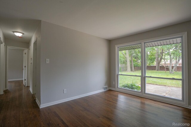 32431 Halmich Dr, Warren, MI 48092 - empty room with dark wood-type flooring and baseboards