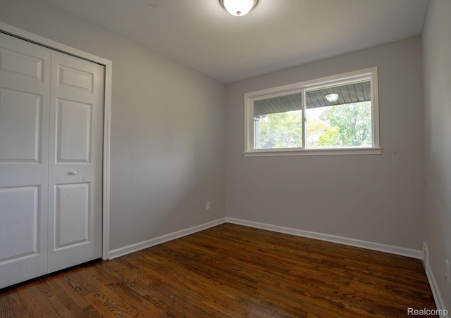 32431 Halmich Dr, Warren, MI 48092 - unfurnished bedroom with dark wood-style flooring and a closet