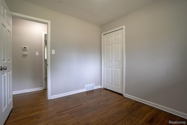 32431 Halmich Dr, Warren, MI 48092 - unfurnished bedroom with dark wood finished floors and baseboards