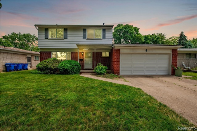 27416 Audrey Ave, Macomb, MI 48092 - view of front of home featuring a garage, driveway, brick siding, and a front lawn
