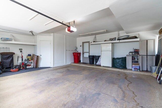 5156 Chestershire Ct, West Bloomfield, MI 48322 - garage featuring freestanding refrigerator and a garage door opener
