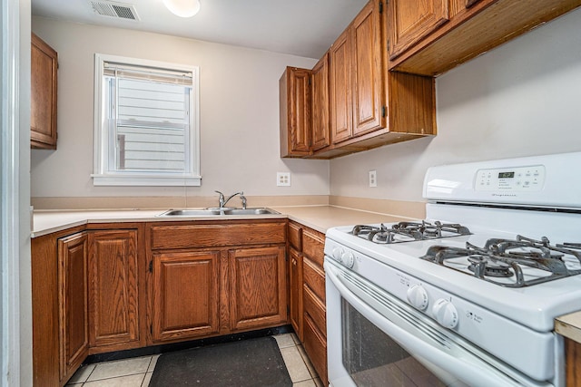 81 Chopin Ave, Troy, MI 48083 - kitchen featuring gas range gas stove, brown cabinetry, and light countertops