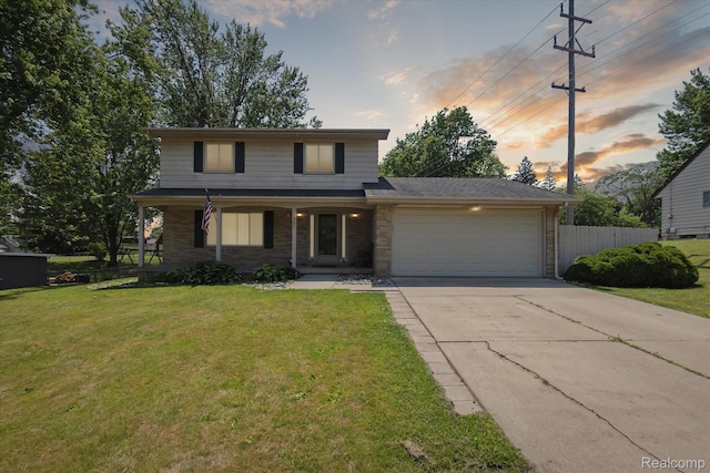 1337 Heathercrest Dr, Flint, MI 48532 - traditional home with a garage, driveway, covered porch, and brick siding