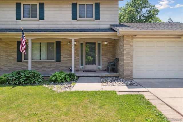 1337 Heathercrest Dr, Flint, MI 48532 - view of front of home featuring a porch, brick siding, an attached garage, a front lawn, and concrete driveway