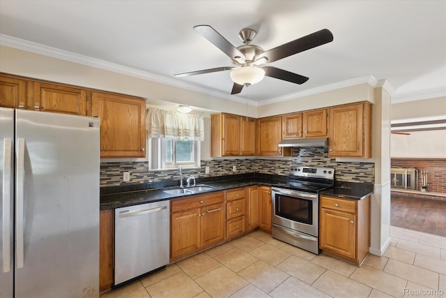 1337 Heathercrest Dr, Flint, MI 48532 - kitchen with stainless steel appliances, under cabinet range hood, ceiling fan, brown cabinetry, and ornamental molding