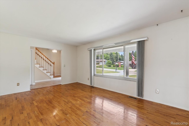 1337 Heathercrest Dr, Flint, MI 48532 - spare room featuring stairway and light wood-style flooring