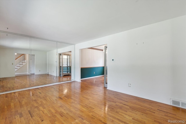 1337 Heathercrest Dr, Flint, MI 48532 - spare room with light wood-type flooring and stairway
