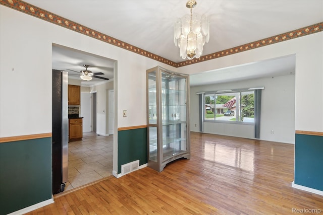 1337 Heathercrest Dr, Flint, MI 48532 - unfurnished room with light wood-style floors, a chandelier, and a ceiling fan