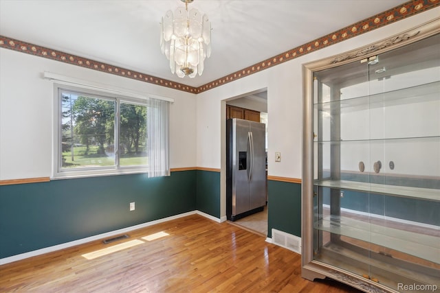 1337 Heathercrest Dr, Flint, MI 48532 - unfurnished dining area featuring a chandelier and light wood-type flooring