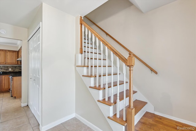 1337 Heathercrest Dr, Flint, MI 48532 - staircase with baseboards and tile patterned flooring